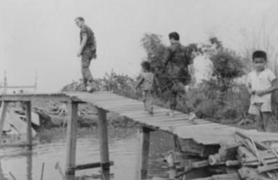 constructing a canal bridge at FOB My Dien I (March 70) Cpt Kulik crossing completed bridge
