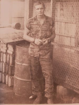 20230426_A421_SSG Ron Owles
SSG Ron Owles, Weapons Sgt. Typical team uniform of Tiger fatigues; standing in front of chicken coop (team had 100 chickens as a Civic Action program - we ended up eating them; no eggs as the coop was 25 yards from the 105mm/4.2" mortar pits).  SSG Owles was career SF - retired as CSM.
Keywords: SSG Ron Owles, A421